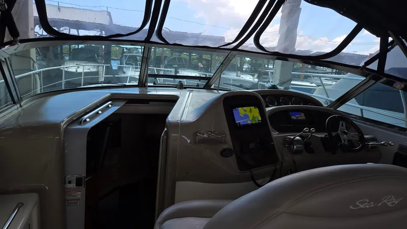 Slide: The Image of 2004 Sea Ray 380 Sundancer cockpit with navigation equipment and helm controls. - 15