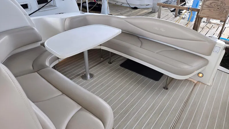 Slide: The Image of Luxurious seating area on 2004 Sea Ray 380 Sundancer yacht with beige upholstery and table. - 17