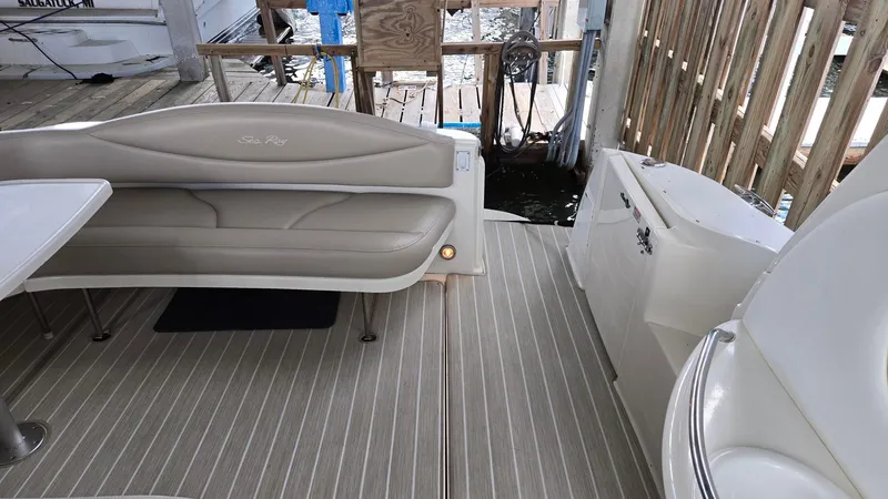Slide: The Image of 2004 Sea Ray 380 Sundancer boat interior with beige seating and striped flooring. - 18