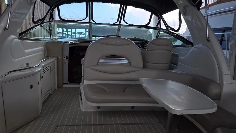 Slide: The Image of 2004 Sea Ray 380 Sundancer interior with seating and table, showcasing luxury yacht design. - 19
