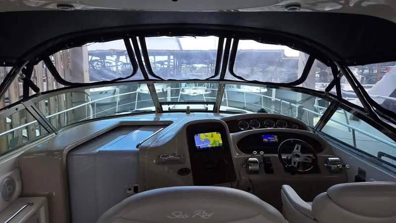 Slide: The Image of 2004 Sea Ray 380 Sundancer helm with navigation system and steering wheel. - 20