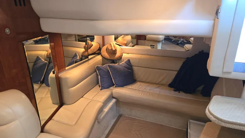 Slide: The Image of Interior of 2004 Sea Ray 380 Sundancer with beige seating and blue cushions. - 21