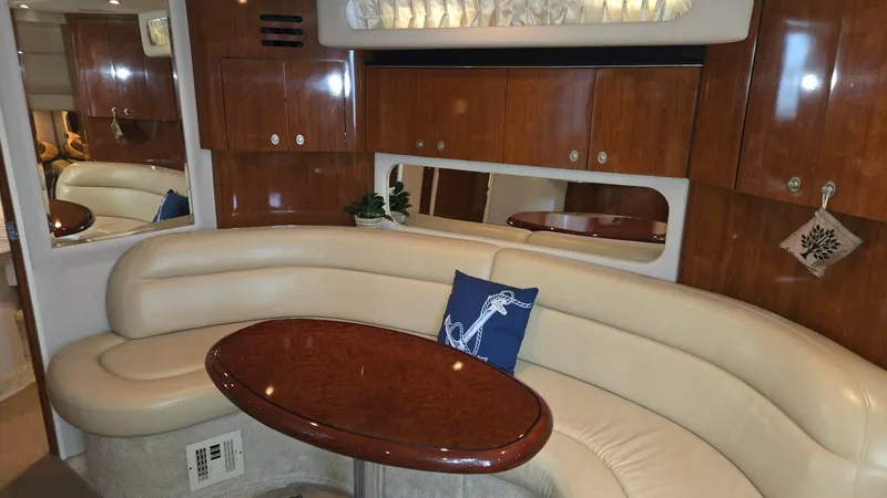 Slide: The Image of Luxurious interior of 2004 Sea Ray 380 Sundancer with elegant seating and wooden cabinetry. - 23