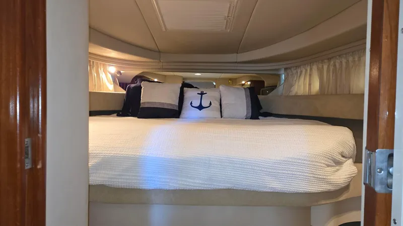 Slide: The Image of Interior cabin of 2004 Sea Ray 380 Sundancer with cozy bedding and nautical-themed pillows. - 25