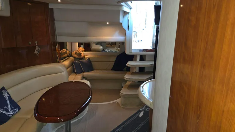 Slide: The Image of Interior of 2004 Sea Ray 380 Sundancer yacht with elegant seating and wooden finishes. - 28
