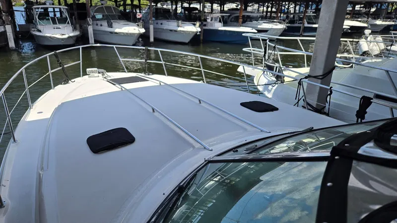 Slide: The Image of 2004 Sea Ray 380 Sundancer docked among other boats in a marina. - 3