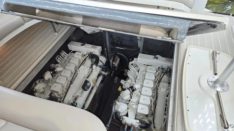 Slide: The Image of 2004 Sea Ray 380 Sundancer engine compartment with dual engines visible. - 30
