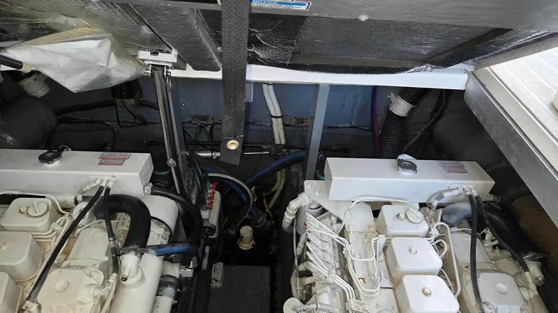 Slide: The Image of Engine compartment of 2004 Sea Ray 380 Sundancer with dual engines visible. - 34