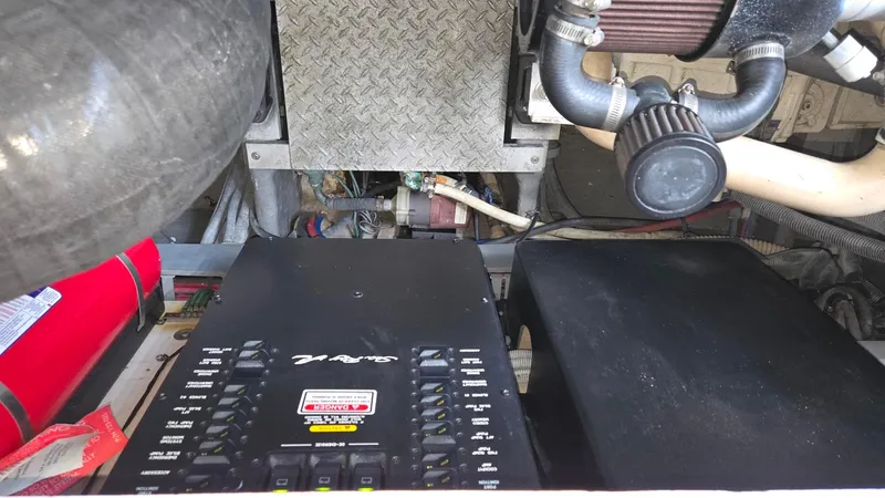 Slide: The Image of Engine compartment of a 2004 Sea Ray 380 Sundancer with visible components and wiring. - 35