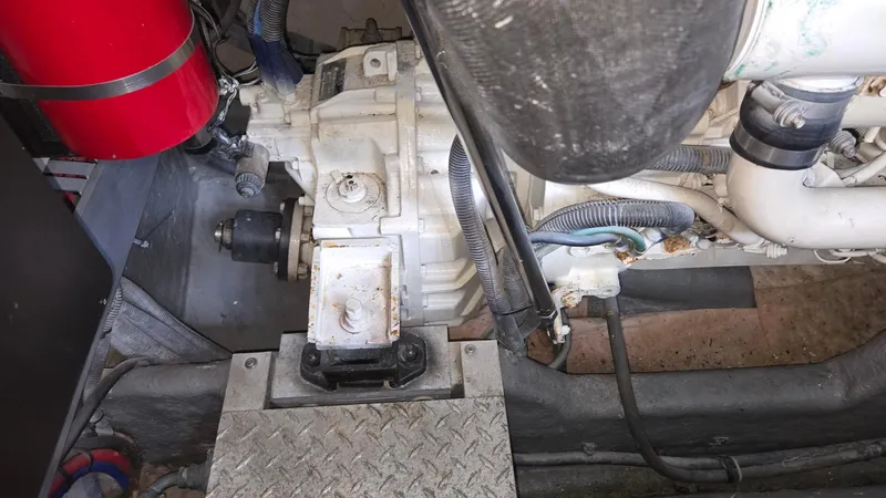 Slide: The Image of Engine compartment of a 2004 Sea Ray 380 Sundancer boat, showing mechanical components. - 36