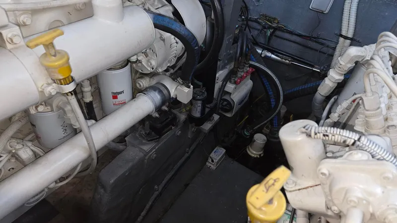 Slide: The Image of Engine compartment of 2004 Sea Ray 380 Sundancer, showcasing mechanical components and wiring. - 37