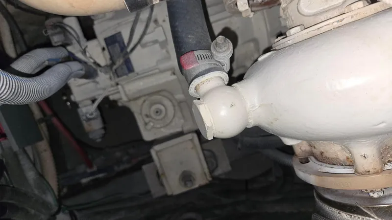 Slide: The Image of Engine compartment of a 2004 Sea Ray 380 Sundancer boat, showing hoses and mechanical components. - 38