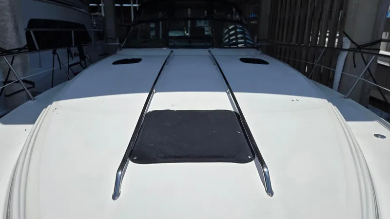 Slide: The Image of 2004 Sea Ray 380 Sundancer boat deck with railings in a marina. - 4