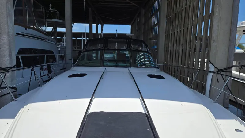 Slide: The Image of 2004 Sea Ray 380 Sundancer docked in a covered marina. - 5