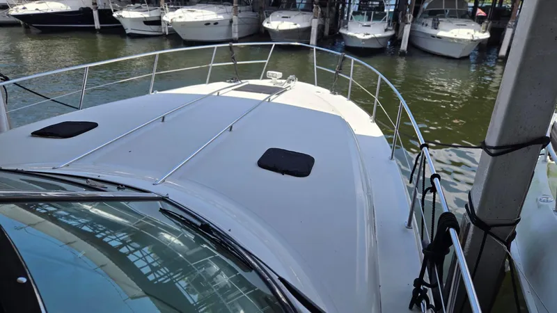 Slide: The Image of 2004 Sea Ray 380 Sundancer yacht docked at marina, view from bow. - 6