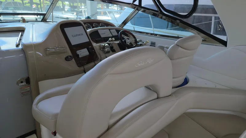 Slide: The Image of 2004 Sea Ray 380 Sundancer helm with leather seating and modern controls. - 9