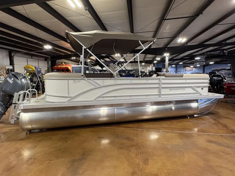 The Image of 2025 Bennington 23 SSR pontoon boat in showroom, side view with canopy. - 1