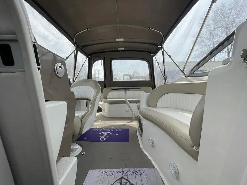 Slide: The Image of Interior of a 2014 Stingray 250CS boat with seating and canopy. - 12