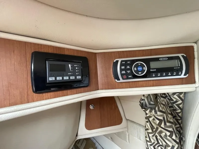 Slide: The Image of Control panel of a 2014 Stingray 250CS boat with wood finish and modern electronics. - 13
