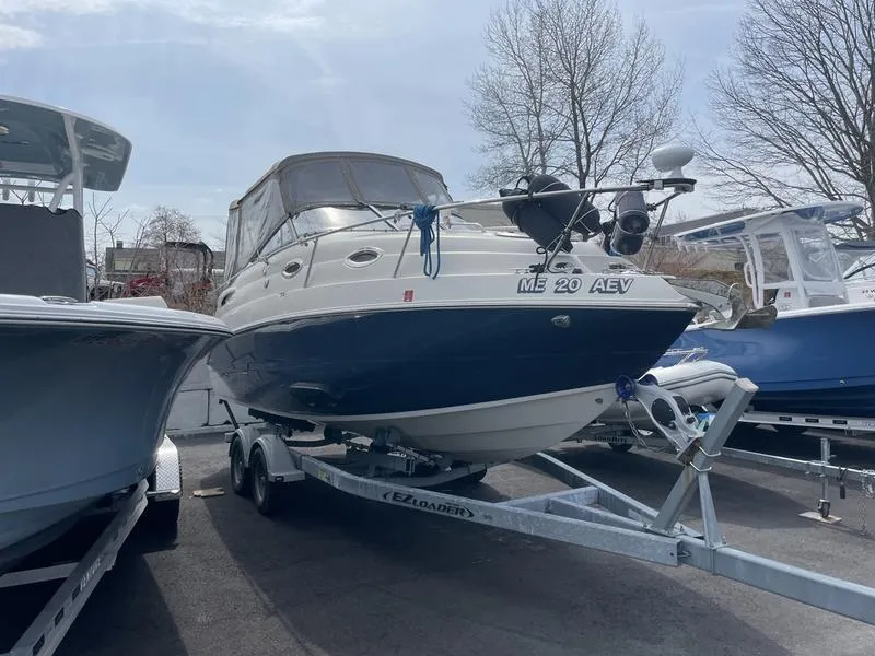 Slide: The Image of 2014 Stingray 250CS boat on trailer, parked outdoors. - 3