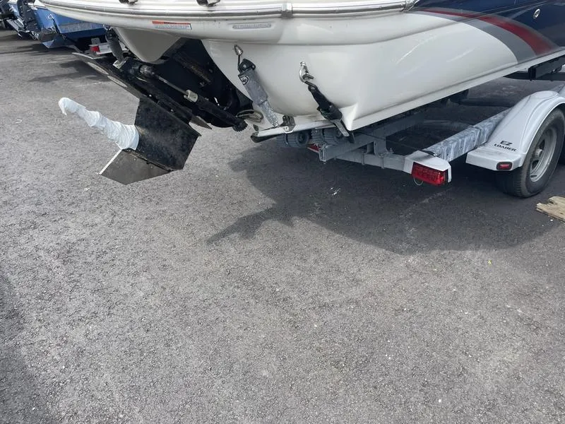Slide: The Image of 2014 Stingray 250CS boat on trailer, rear view showing propeller and outdrive. - 4