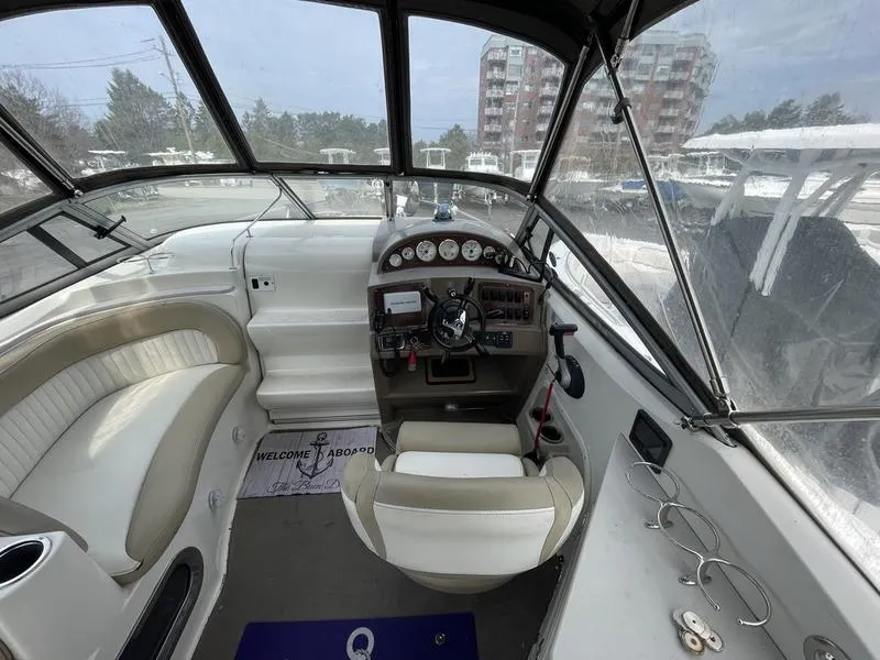 Slide: The Image of Interior view of 2014 Stingray 250CS boat cockpit with steering wheel and seating. - 7