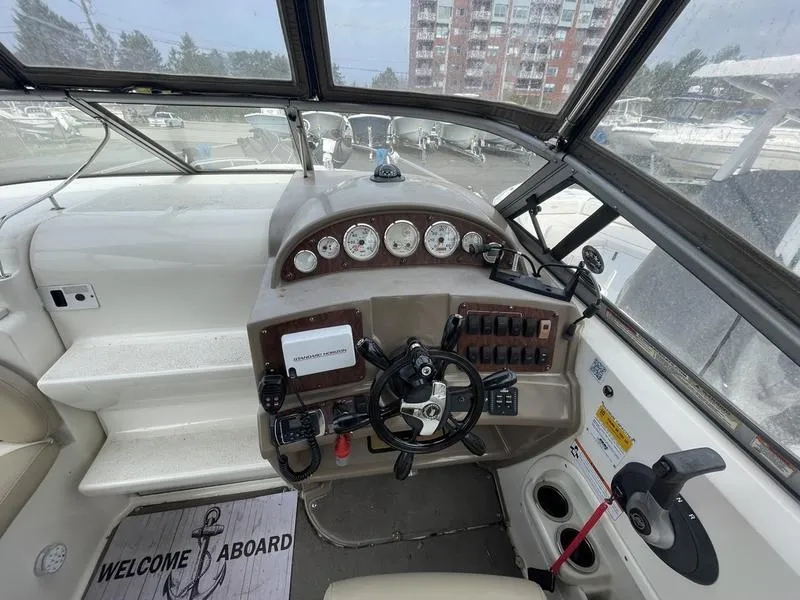 Slide: The Image of Cockpit of 2014 Stingray 250CS boat with steering wheel and control panel. - 8