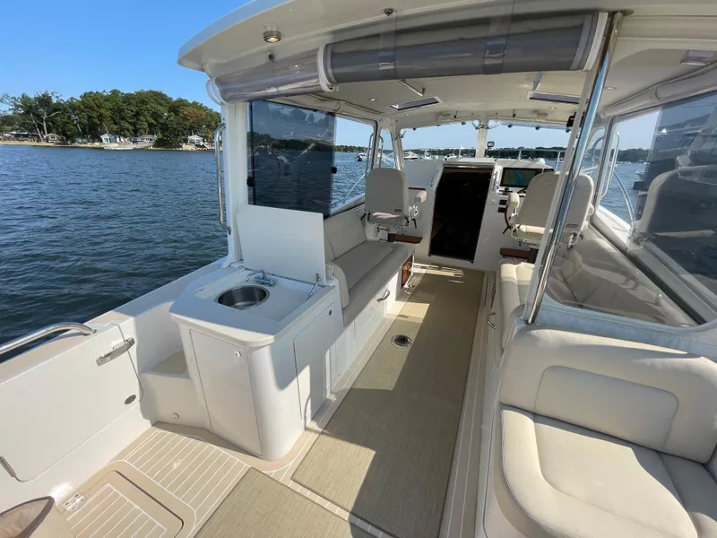 Slide: The Image of 2020 MJM 35z boat interior with seating, water view, and open cabin layout. - 12