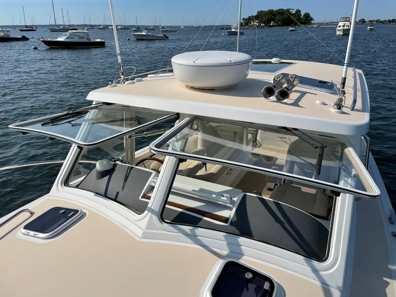 Slide: The Image of 2020 MJM 35z boat on water with open windows and visible seating area. - 14