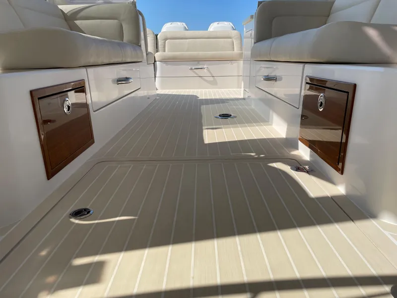 Slide: The Image of Luxurious interior of 2020 MJM 35z boat with cushioned seating and wooden accents. - 16