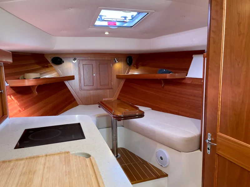 Slide: The Image of Interior of 2020 MJM 35z boat with wood paneling and seating area. - 19