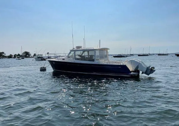 Slide: The Image of 2020 MJM 35z boat on calm water with other boats in the background. - 2