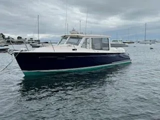 Slide: The Image of 2020 MJM 35z boat on water, cloudy sky, other boats in background. - 27