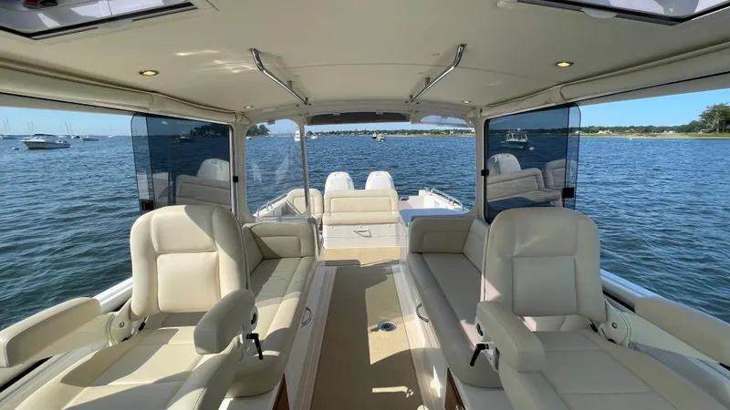 Slide: The Image of Interior view of 2020 MJM 35z boat with luxurious seating and scenic water backdrop. - 4