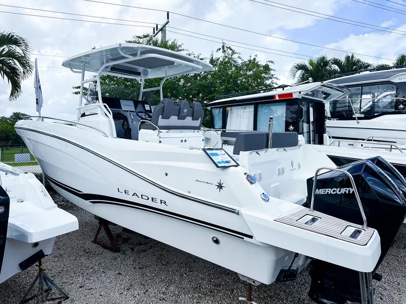 Slide: The Image of 2024 Jeanneau LEADER 9.0CC boat with Mercury engine, displayed outdoors. - 0