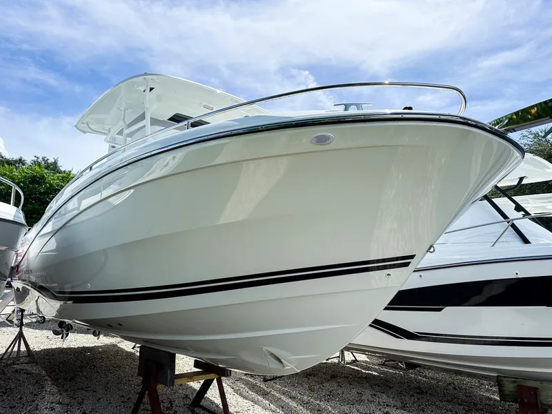 Slide: The Image of 2024 Jeanneau LEADER 9.0CC boat with sleek design, displayed outdoors. - 1