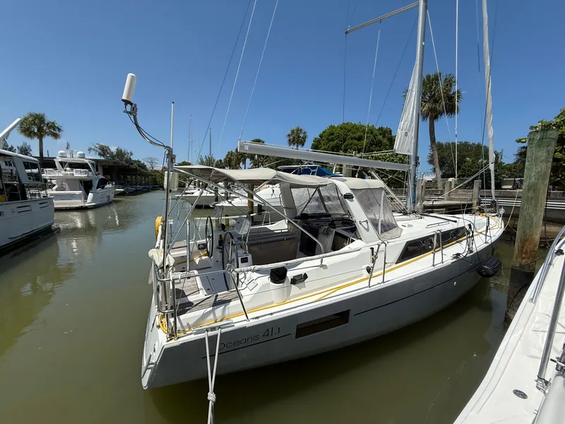 Slide: The Image of 2017 Beneteau Oceanis 41.1 sailboat docked in a sunny marina. - 12