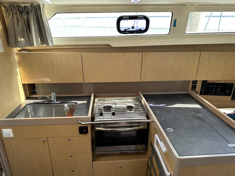 Slide: The Image of Interior of 2017 Beneteau Oceanis 41.1 yacht kitchen with stove, sink, and cabinets. - 15