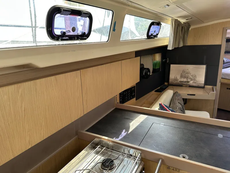 Slide: The Image of Interior of 2017 Beneteau Oceanis 41.1 yacht, featuring modern kitchen and seating area. - 16