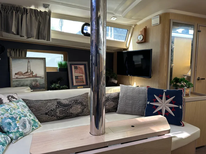 Slide: The Image of Interior of 2017 Beneteau Oceanis 41.1 yacht with cozy seating and nautical decor. - 18