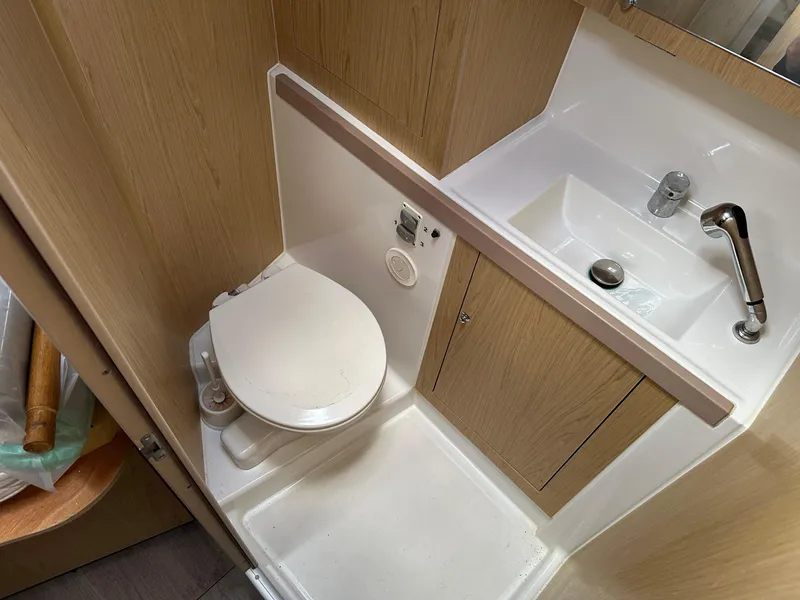 Slide: The Image of Bathroom interior of 2017 Beneteau Oceanis 41.1 yacht, featuring toilet and sink. - 19