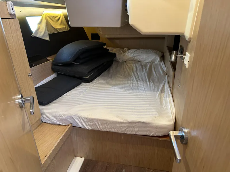 Slide: The Image of Cozy cabin interior of 2017 Beneteau Oceanis 41.1 sailboat with bed and wooden finish. - 24