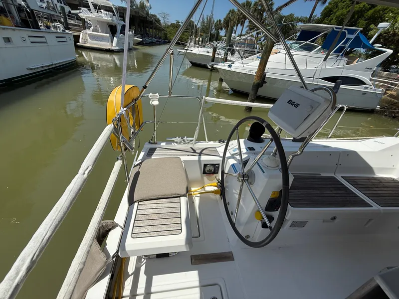 Slide: The Image of 2017 Beneteau Oceanis 41.1 sailboat cockpit with steering wheel, docked in marina. - 25