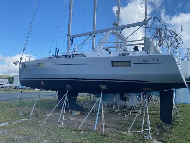 Slide: The Image of 2017 Beneteau Oceanis 41.1 sailboat on stands, displayed outdoors under a blue sky. - 7