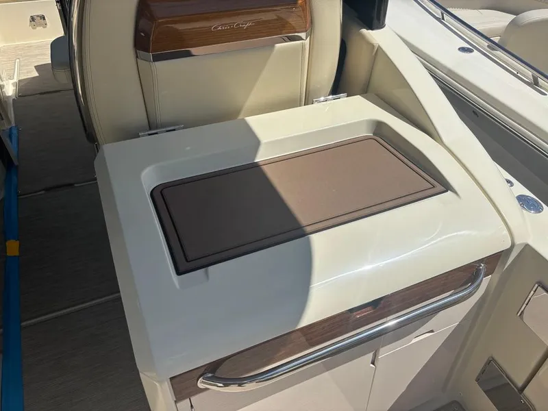 Slide: The Image of 2025 Chris-Craft Calypso 32 boat interior with stainless steel fridge and storage compartments. - 11