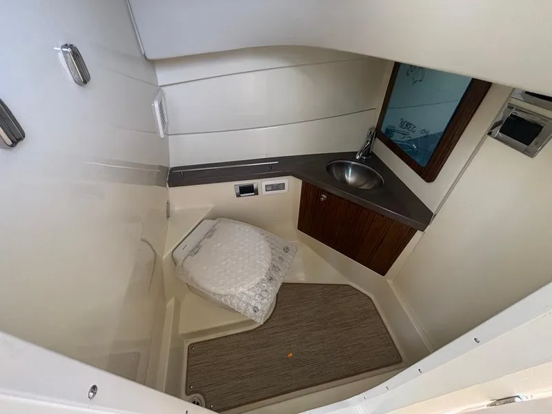 Slide: The Image of 2025 Chris-Craft Calypso 32 interior with luxurious seating and sleek dashboard design. - 16