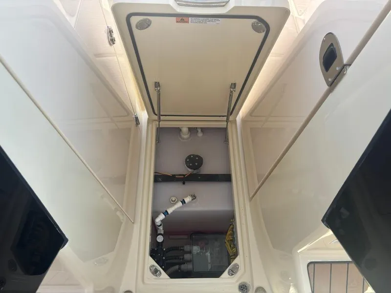Slide: The Image of 2025 Chris-Craft Calypso 32 boat storage compartments with wooden doors open. - 19