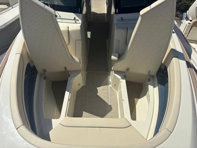 Slide: The Image of 2025 Chris-Craft Calypso 32 boat interior with beige seating and blue accents. - 22