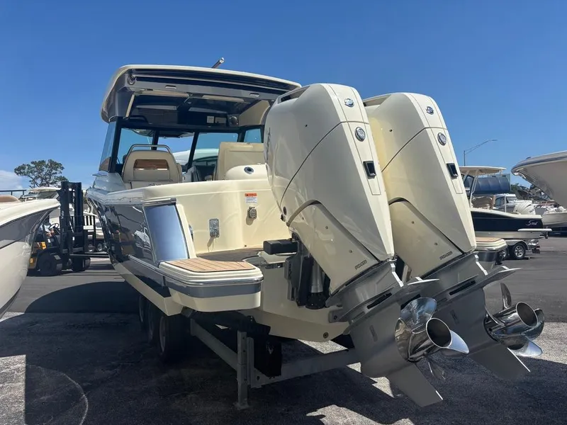 Slide: The Image of 2025 Chris-Craft Calypso 32 boat, front view, displayed outdoors with trees in the background. - 3