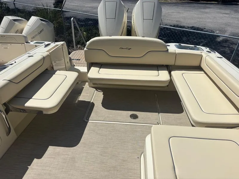 Slide: The Image of 2025 Chris-Craft Calypso 32 boat storage compartment with open lid and beige seating. - 7
